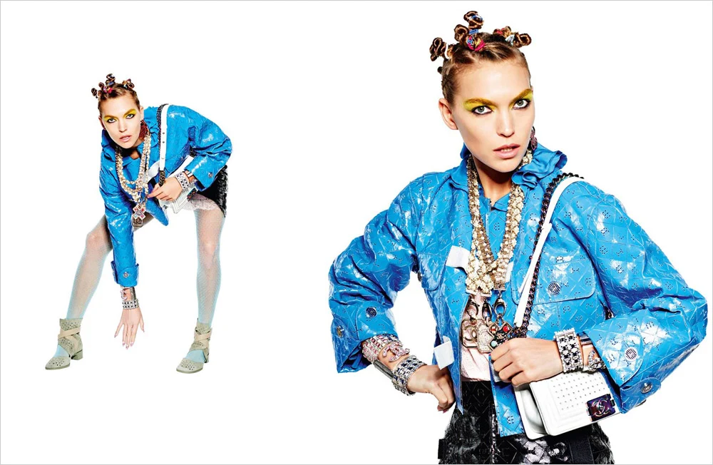 A model in a blue Chanel jacket carrying a white illuminated handbag created with CuteCircuit